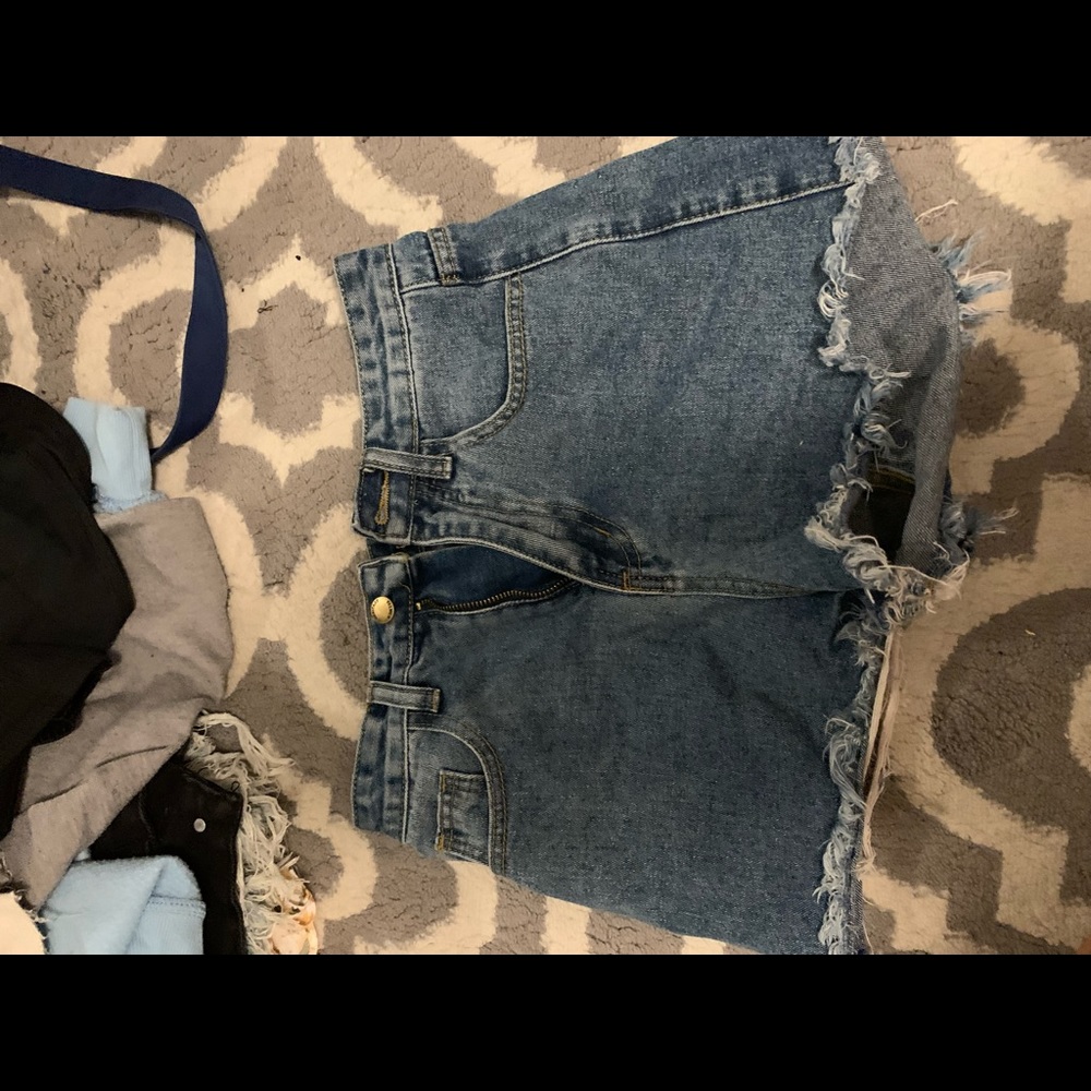 Blue denim ripped jean shorts with dark denim pockets
